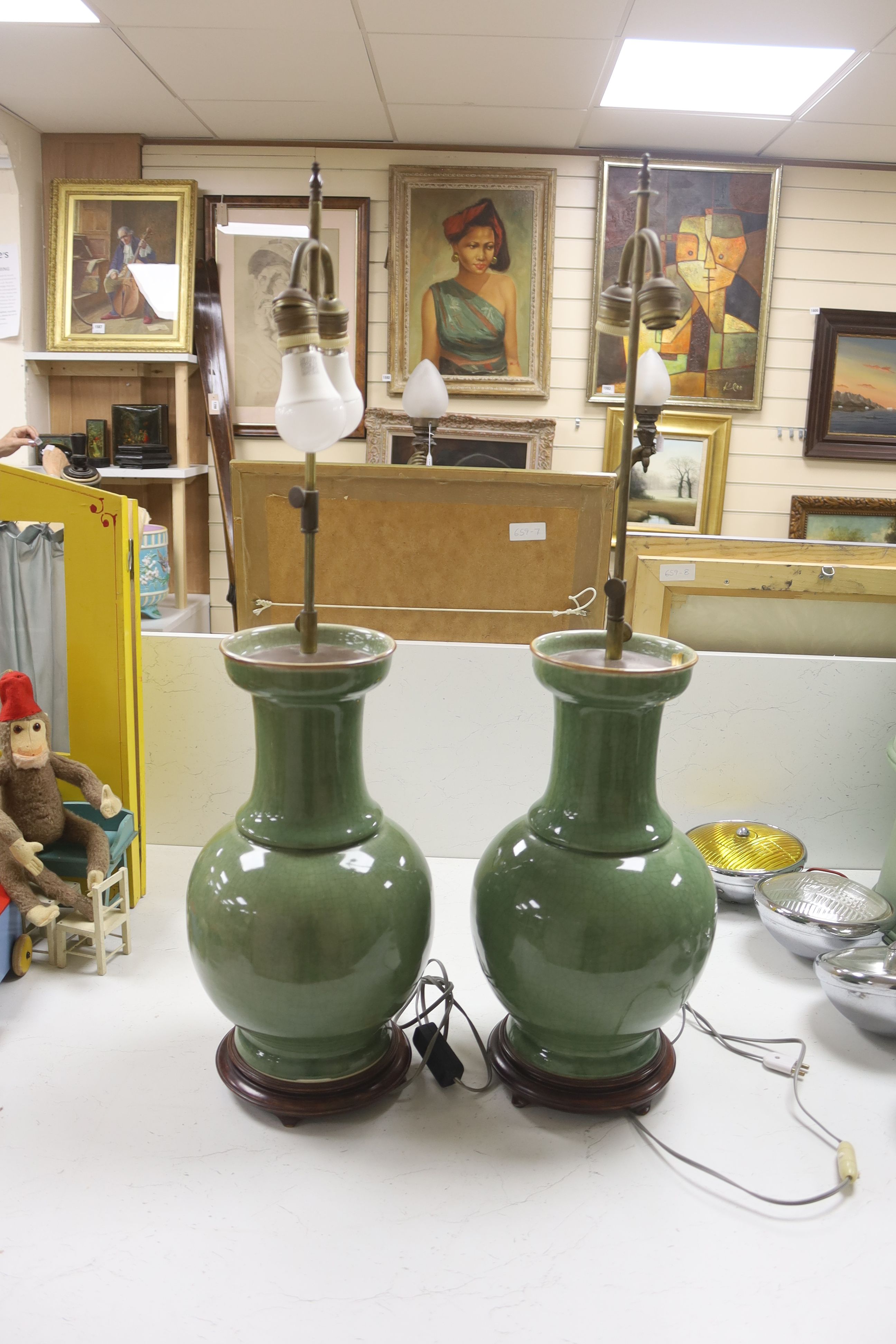 A pair of Chinese celadon crackle glazed table lamps, height 46cm excluding light fitting